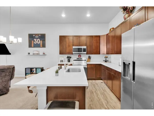 a kitchen with a sink refrigerator and microwave
