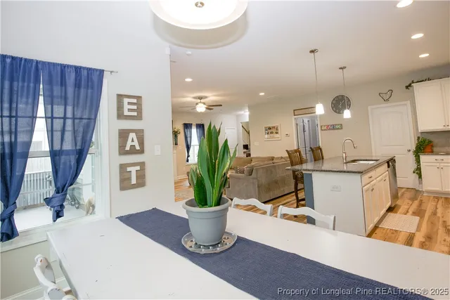 a living room with furniture a window and kitchen view