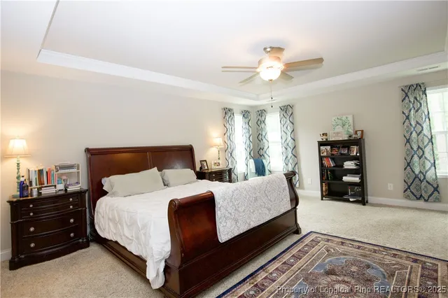 a bedroom with a large bed and a chandelier