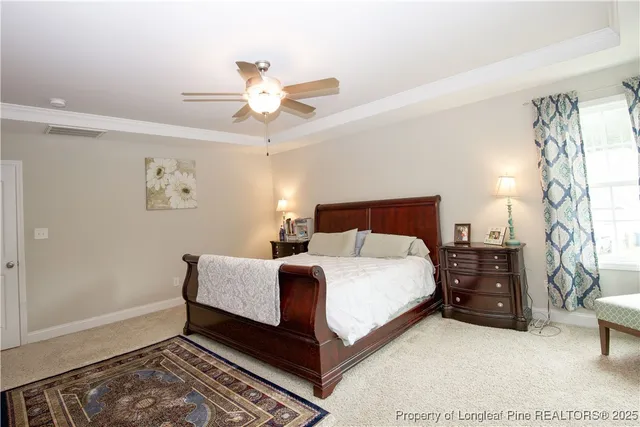 a spacious bedroom with a bed and a chandelier