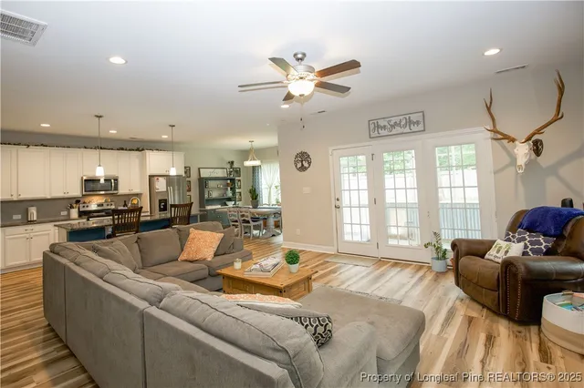 a living room with furniture and a large window