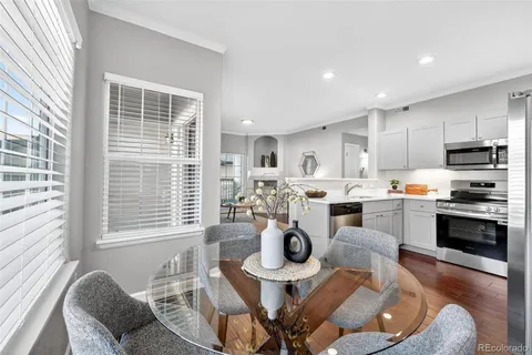 a living room with stainless steel appliances kitchen island granite countertop furniture and a kitchen view