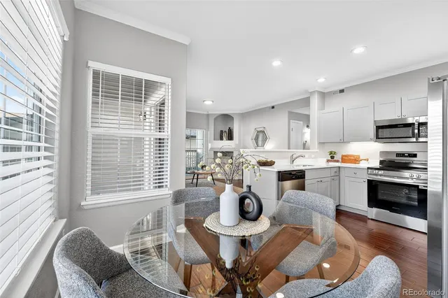 a living room with stainless steel appliances kitchen island granite countertop furniture and a kitchen view