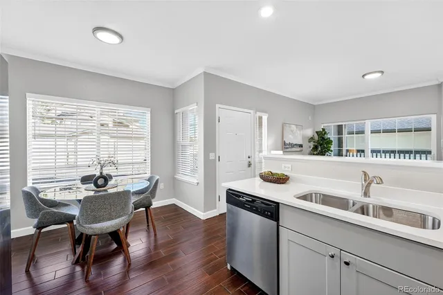 a kitchen with a table chairs and wooden floor