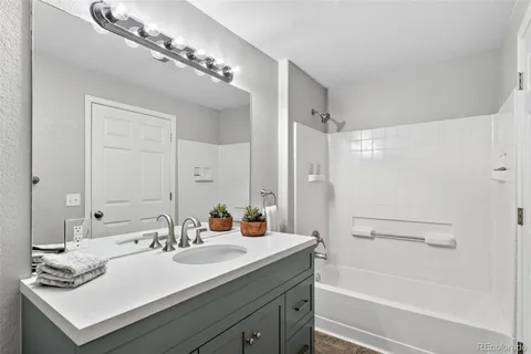 a bathroom with a bathtub a sink and a mirror