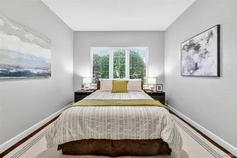 a bedroom with a bed and wall painting