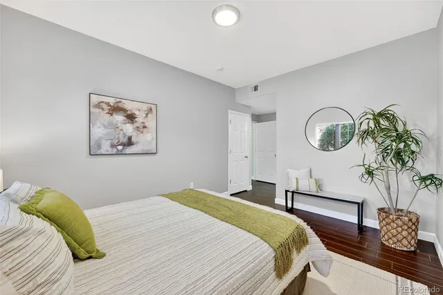 a bedroom with bed and a potted plant