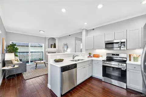 a kitchen with stainless steel appliances kitchen island granite countertop a stove and a sink