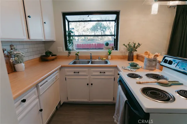 a kitchen that has a lot of cabinets and a couch