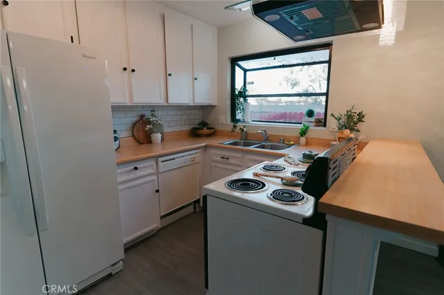 a kitchen with a refrigerator and cabinets