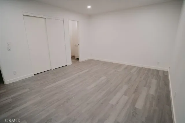 a bathroom with a toilet and a potted plant