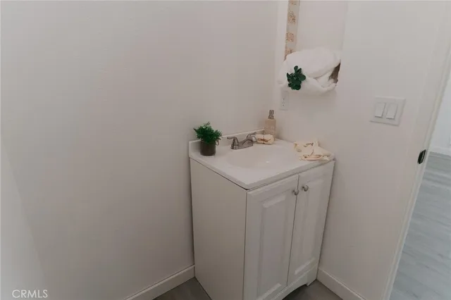 a bathroom with a sink toilet and a window