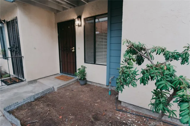an empty room with potted plants in front of door