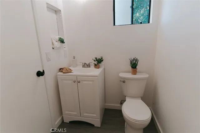 a bedroom with a bed and a potted plant