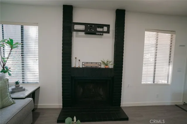 a living room with a fireplace and windows