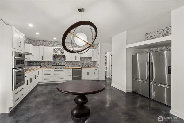 a kitchen with stainless steel appliances granite countertop a stove sink and cabinets