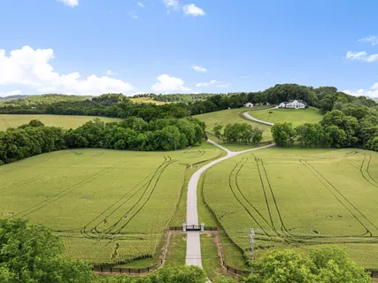 an aerial view of a house with a big yard