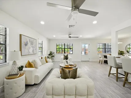 a kitchen with a dining table chairs and wooden floor