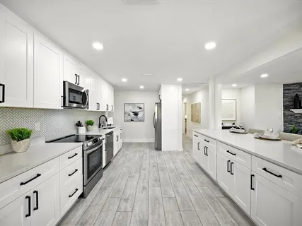 a kitchen with a sink cabinets and refrigerator