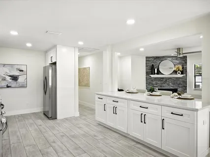 a kitchen with stainless steel appliances granite countertop a sink a stove and a microwave