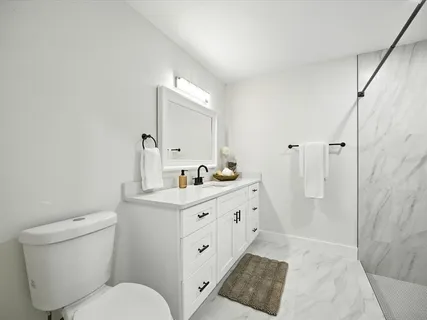 an empty room with wooden floor ceiling fan and windows