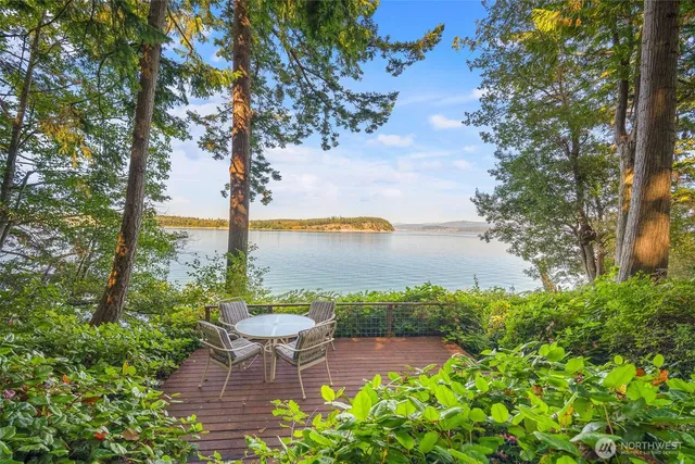 a view of a chairs and table on the wooden deck