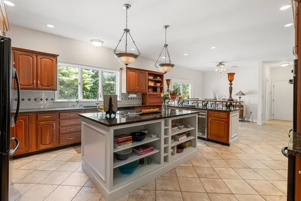 a kitchen with stainless steel appliances granite countertop a stove a sink and a refrigerator