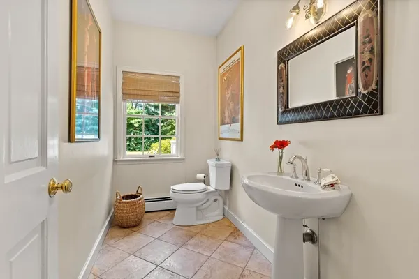 a bathroom with a sink toilet and a mirror