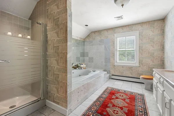a bathroom with a tub shower and sink