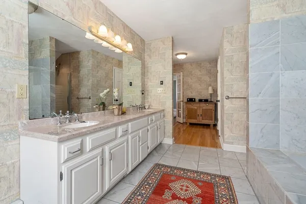 a bathroom with a double vanity sink and a mirror