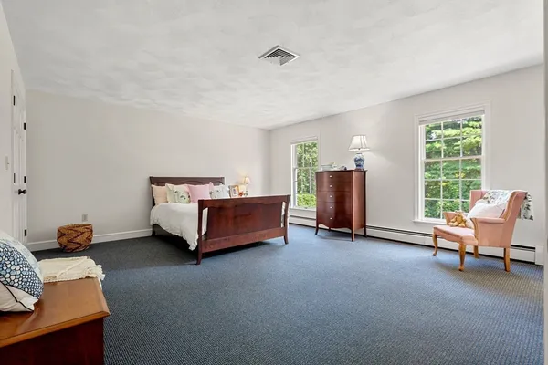 a bedroom with a bed and a couch