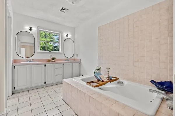 a bathroom with a sink vanity and a mirror