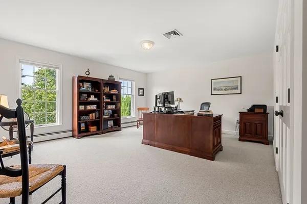 a living room with furniture and a bookshelf