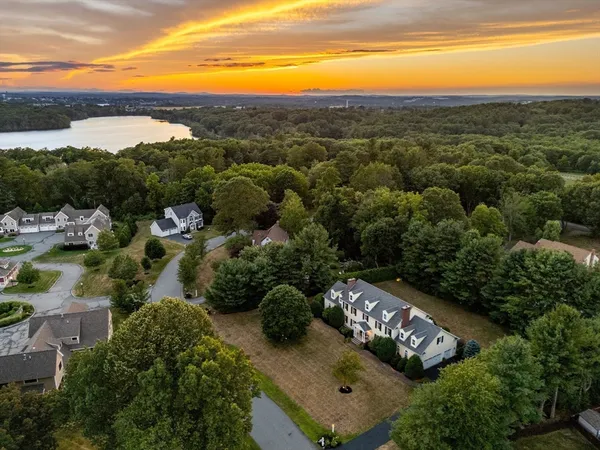 an aerial view of a city with lots of residential buildings ocean and mountain view in back