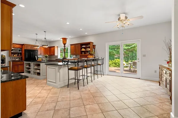 a open kitchen with stainless steel appliances granite countertop a stove top oven a sink a counter top space and cabinets