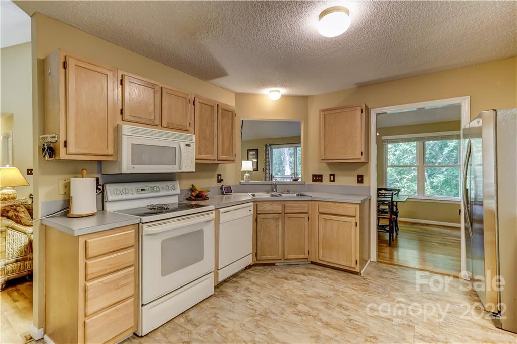 6023 Lanai Lane Tega Cay, SC 29708 - Photo 12 of 43 a kitchen with stainless steel appliances granite countertop a sink and cabinets