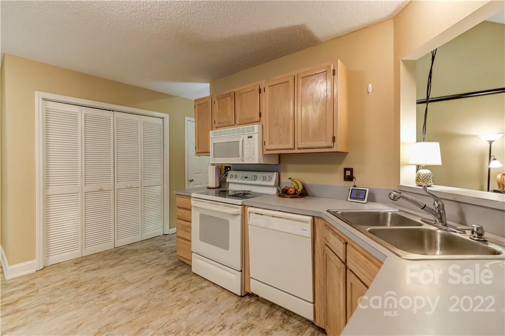 6023 Lanai Lane Tega Cay, SC 29708 - Photo 13 of 43 a kitchen with a sink stove and cabinets