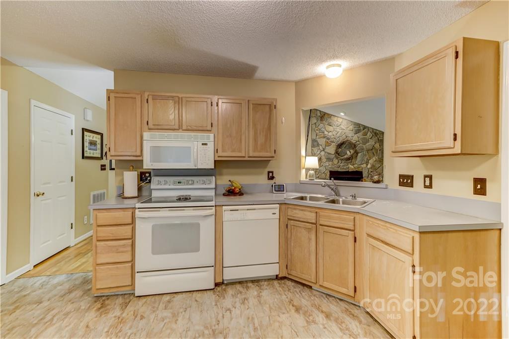 6023 Lanai Lane Tega Cay, SC 29708 - Photo 14 of 43 a kitchen with a stove sink and cabinets