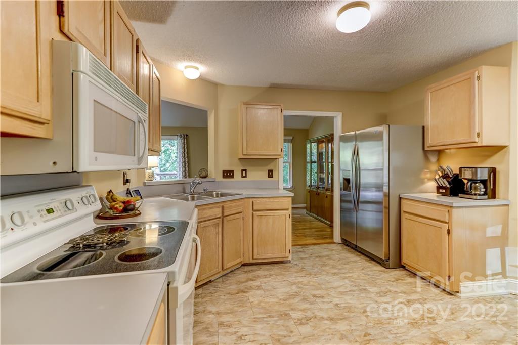 6023 Lanai Lane Tega Cay, SC 29708 - Photo 15 of 43 a kitchen with a sink stove and refrigerator