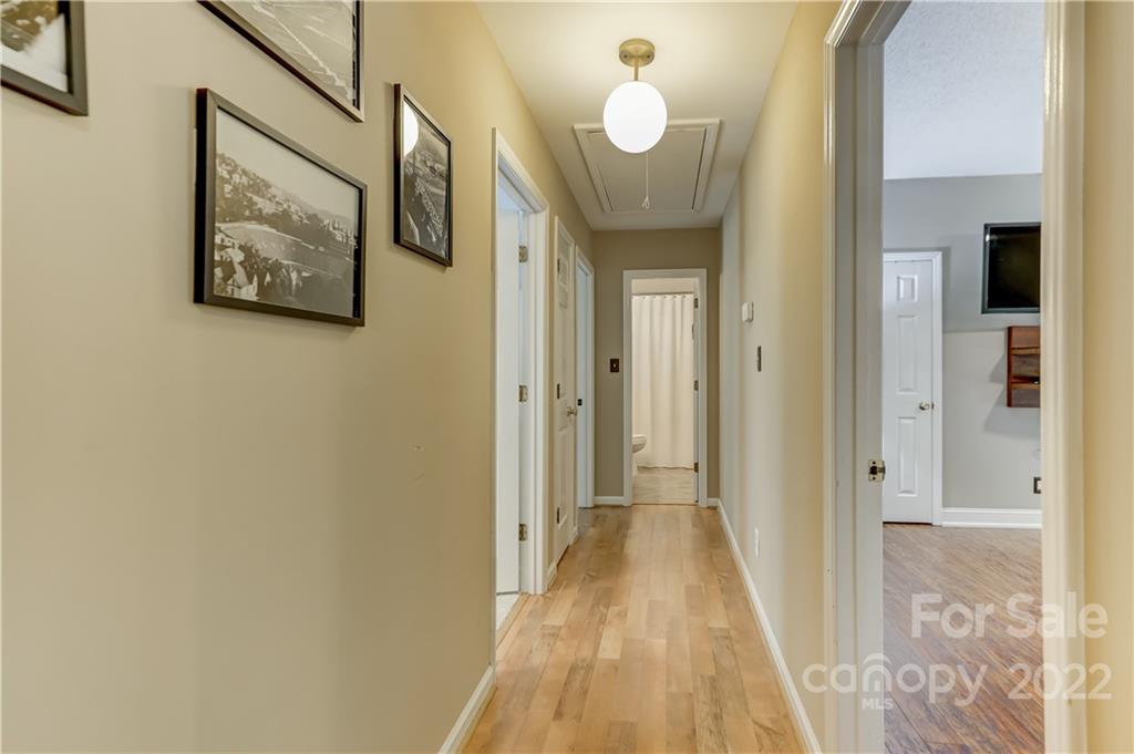 6023 Lanai Lane Tega Cay, SC 29708 - Photo 18 of 43 a view of a hallway with wooden floor and bathroom
