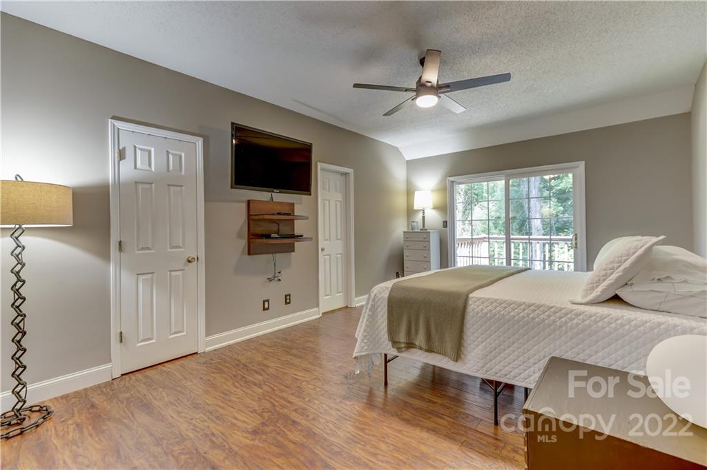 6023 Lanai Lane Tega Cay, SC 29708 - Photo 19 of 43 a bedroom with a bed and a chandelier