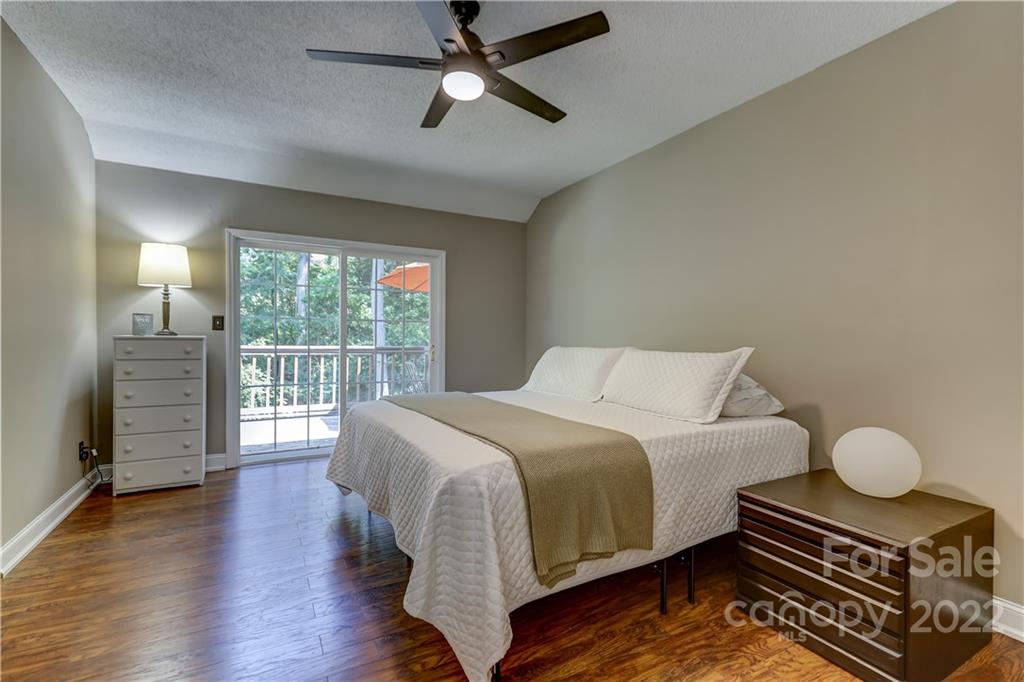 6023 Lanai Lane Tega Cay, SC 29708 - Photo 20 of 43 a bedroom with a bed and wooden floor