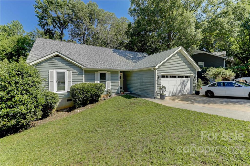 6023 Lanai Lane Tega Cay, SC 29708 - Photo 2 of 43 a front view of a house with a garden