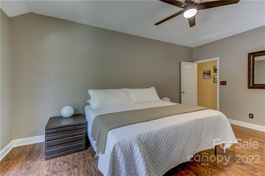 6023 Lanai Lane Tega Cay, SC 29708 - Photo 21 of 43 a bedroom with a bed and cabinets
