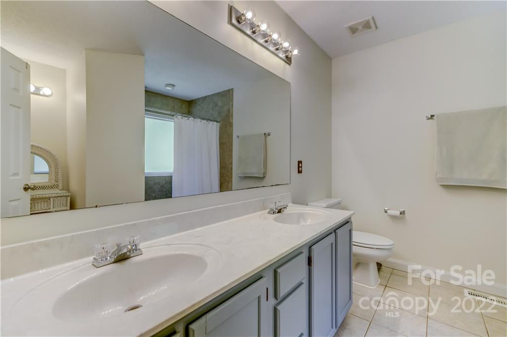 6023 Lanai Lane Tega Cay, SC 29708 - Photo 23 of 43 a bathroom with a sink a toilet and a mirror