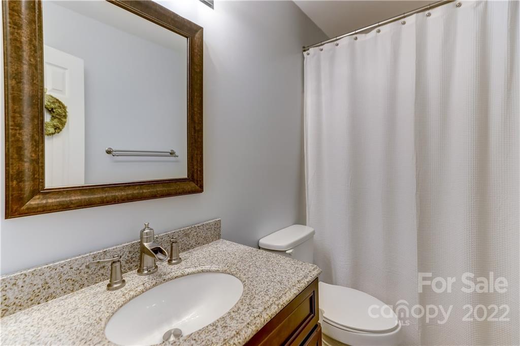 6023 Lanai Lane Tega Cay, SC 29708 - Photo 31 of 43 a bathroom with a granite countertop sink vanity mirror and toilet