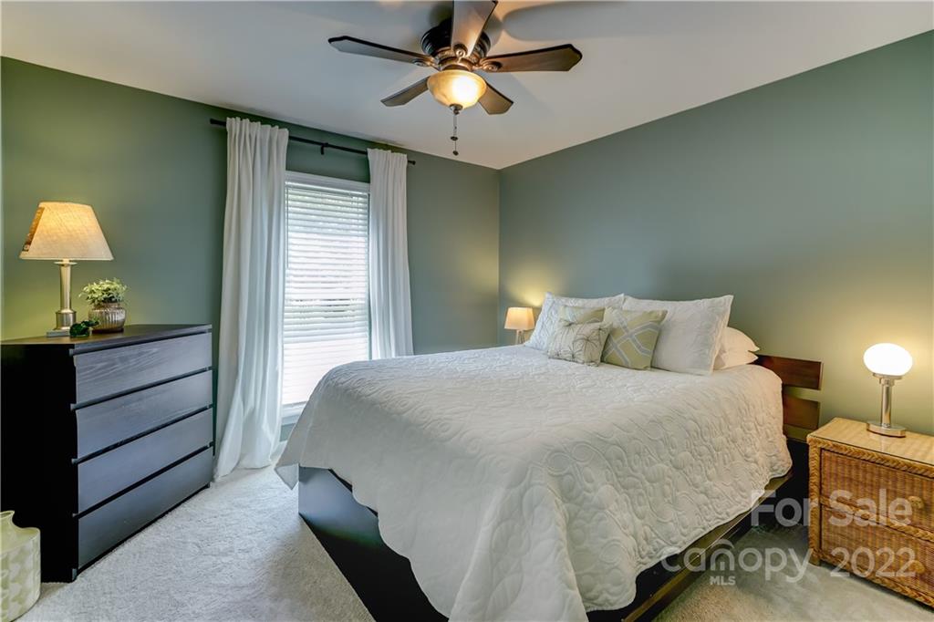 6023 Lanai Lane Tega Cay, SC 29708 - Photo 32 of 43 a bedroom with a bed and a lamp