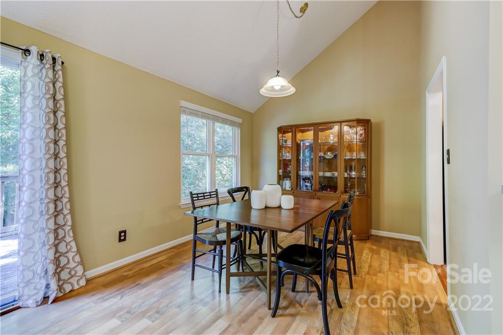 6023 Lanai Lane Tega Cay, SC 29708 - Photo 8 of 43 a view of a dining room with furniture and wooden floor