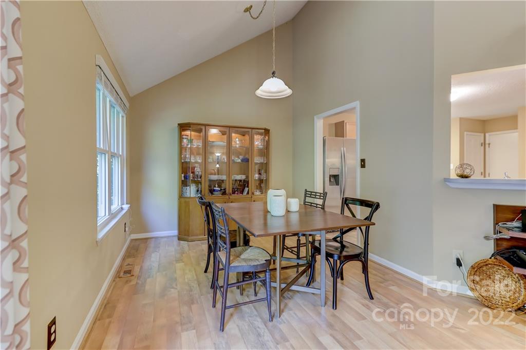 6023 Lanai Lane Tega Cay, SC 29708 - Photo 9 of 43 a view of a dining room with furniture and wooden floor