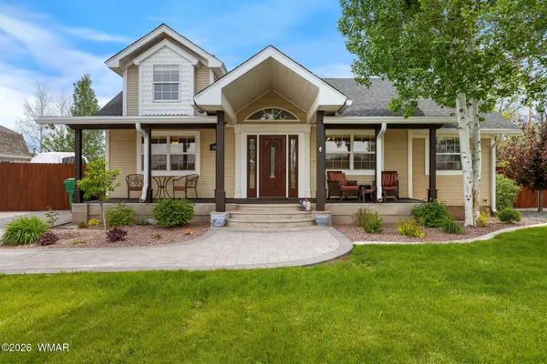 a front view of a house with a yard and porch